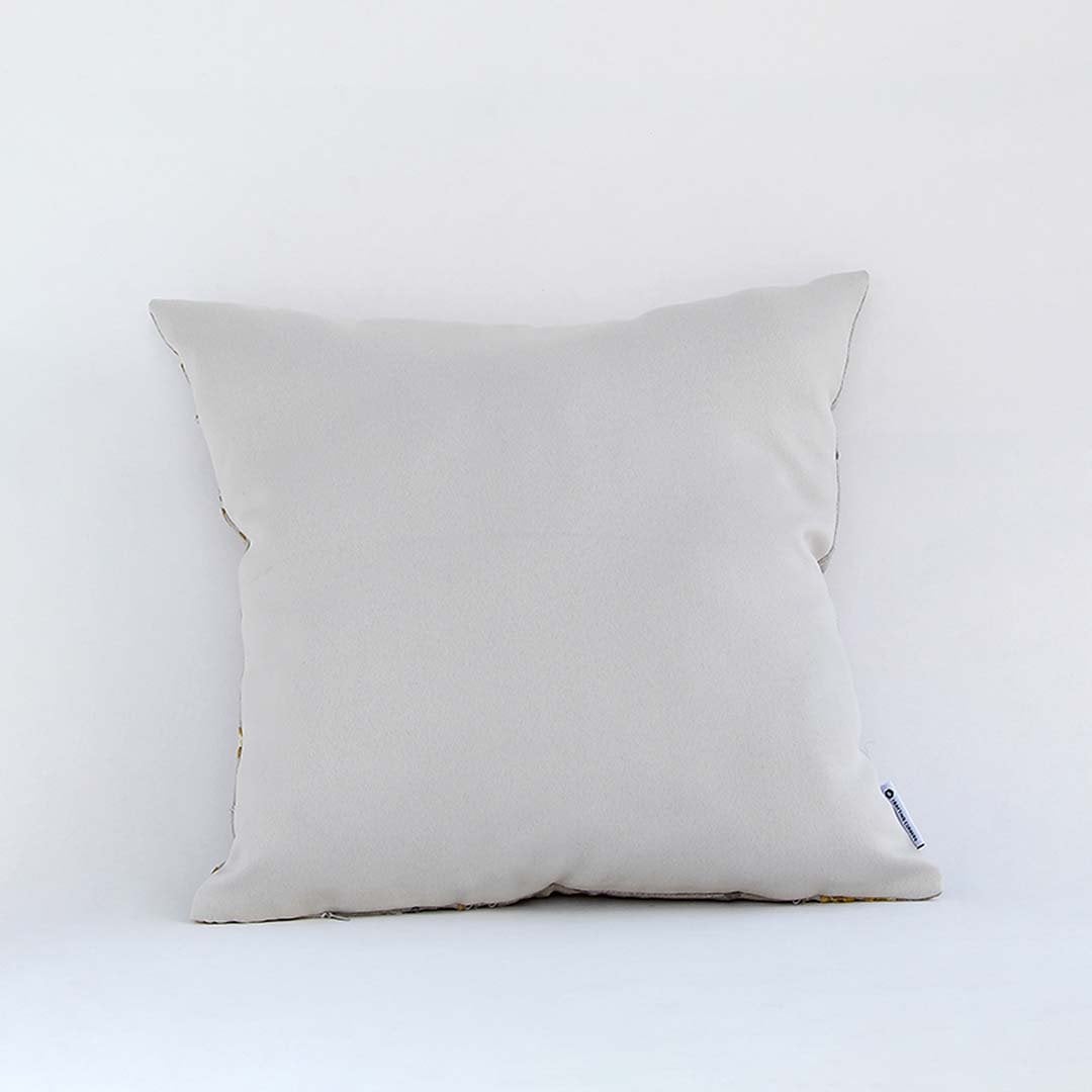 Back view of beige embroidered cushion cover with zipper closure is a decorative pillow cover for sofas and chairs.