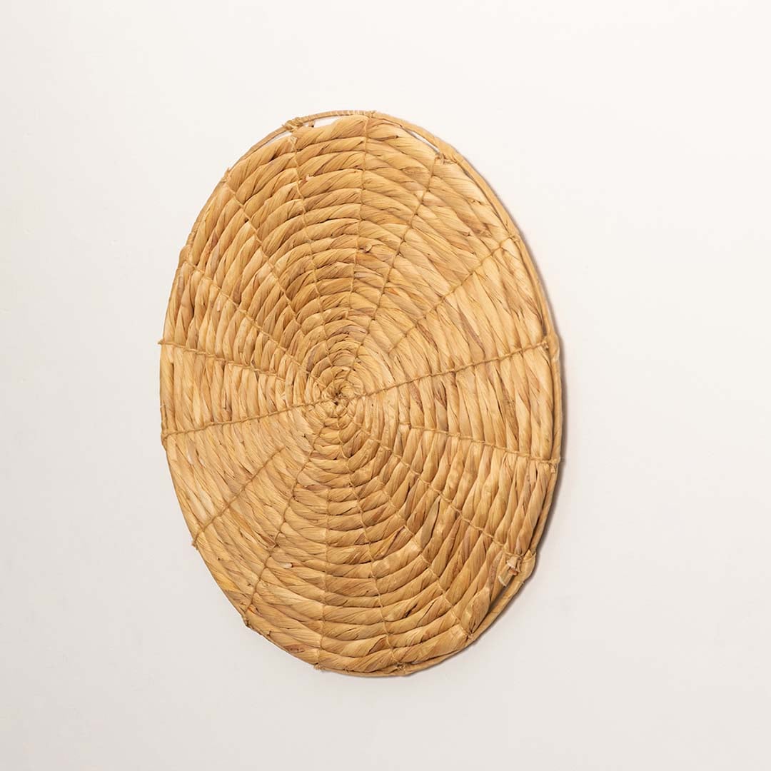 Side view of wicker wall decor plate showcasing woven depth and round structure.