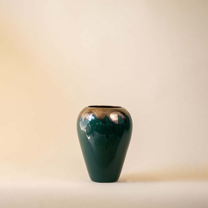 Dark green ceramic decorative vase with glossy finish for shelf styling and sophisticated modern home decor.