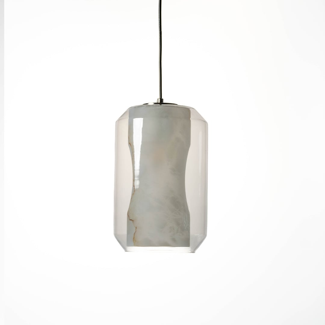 A glowing marble effect pendant light with transparent cylindrical glass body and soft warm illumination displayed on a clean white background for modern decor.