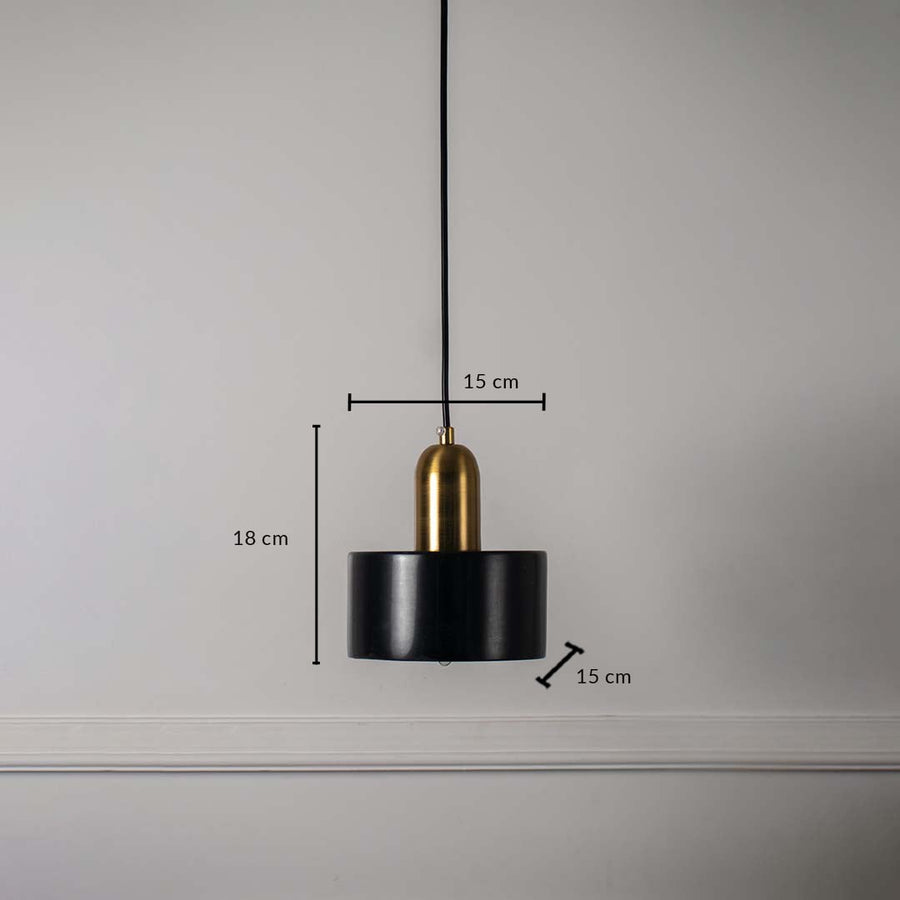 Black and gold cylindrical pendant ceiling light with height 18 cm and diameter 15 cm displayed clearly on off white wall.