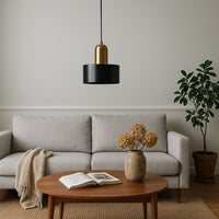 Black marble pendant light above coffee table bringing sophisticated charm and ambient warmth indoors.