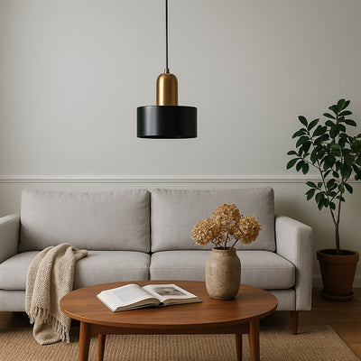 Black marble pendant light above coffee table bringing sophisticated charm and ambient warmth indoors.