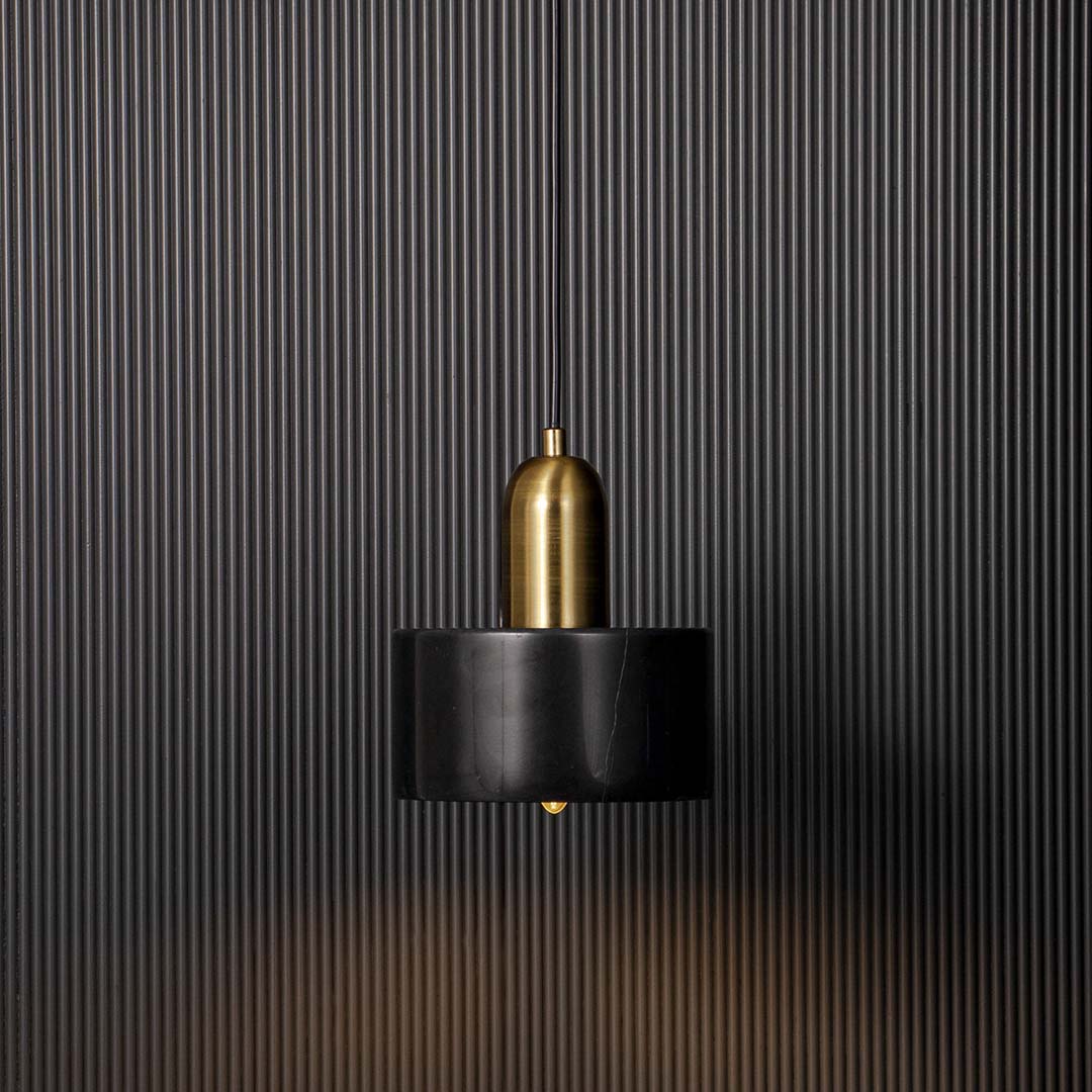 Elegant black and gold pendant ceiling light glowing warmly against black background adding luxury and charm to interiors.