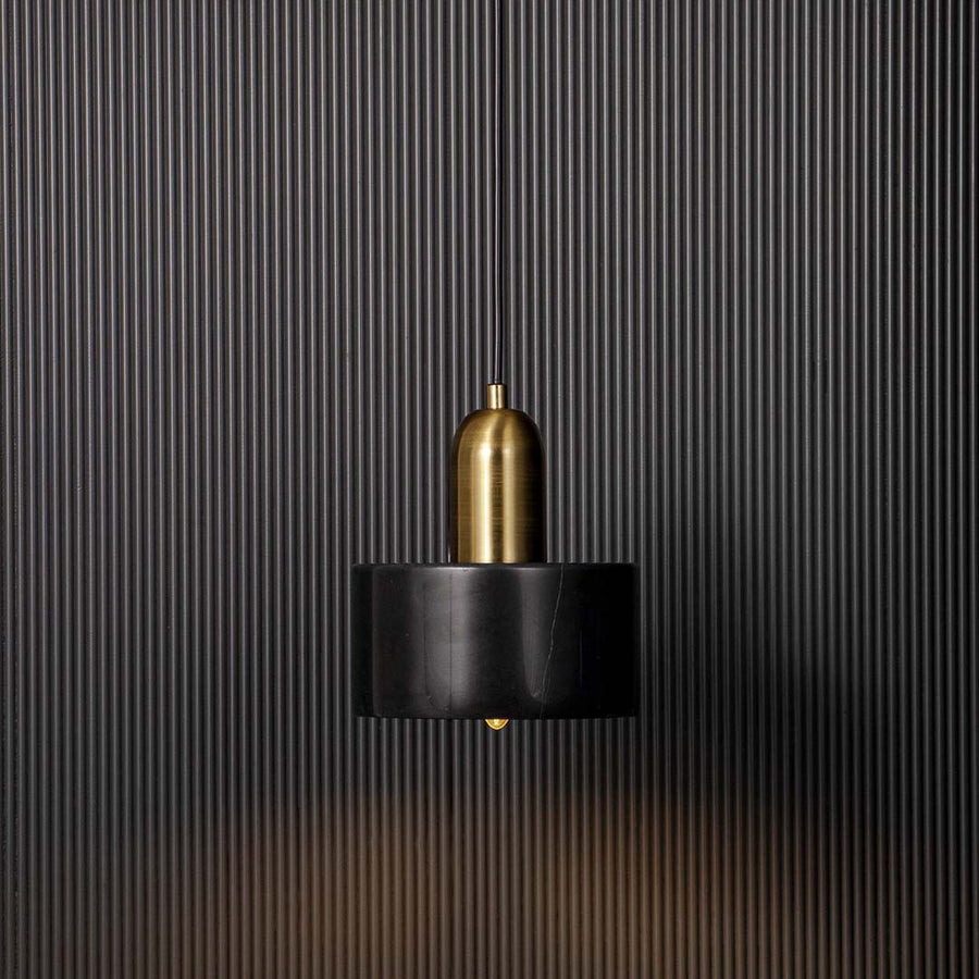Elegant black and gold pendant ceiling light glowing warmly against black background adding luxury and charm to interiors.