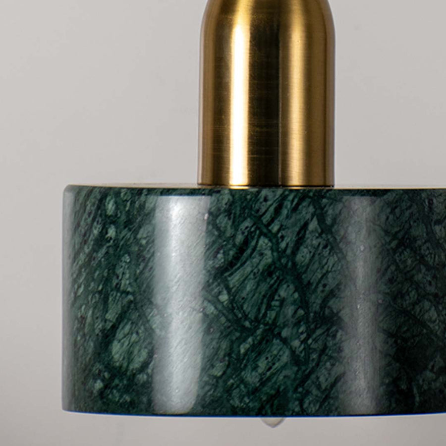 Closeup of green marble and gold cylindrical pendant light highlighting smooth finish and premium modern ceiling decor style.