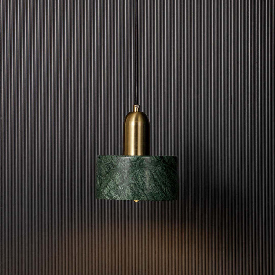 Stylish green marble and gold pendant ceiling light glowing beautifully against black background creating modern luxury vibe.