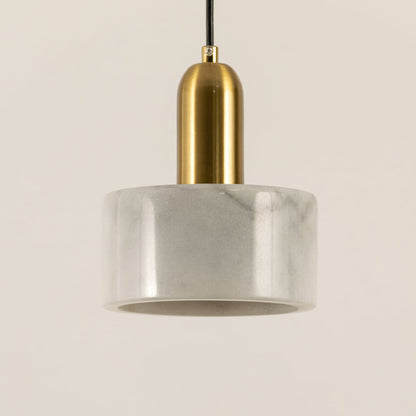 Closeup of white marble pendant light with brushed gold details showcasing premium craftsmanship.