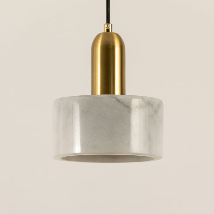 Closeup of white marble pendant light with brushed gold details showcasing premium craftsmanship.