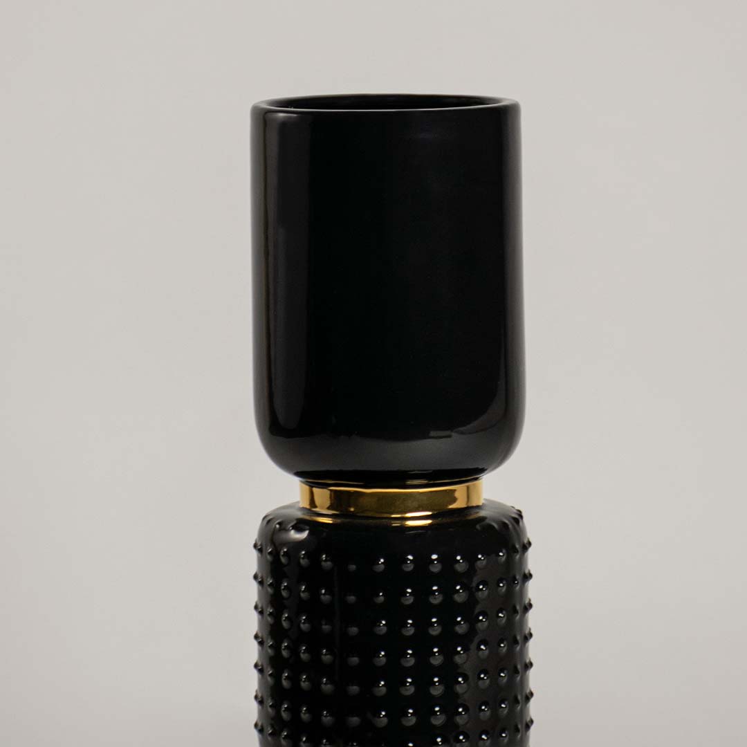 Detailed view of polished black and gold stacked segment vase for refined artistic modern home interior decor accents.