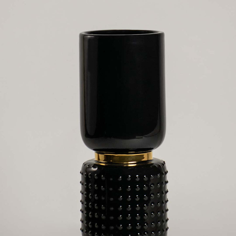 Detailed view of polished black and gold stacked segment vase for refined artistic modern home interior decor accents.
