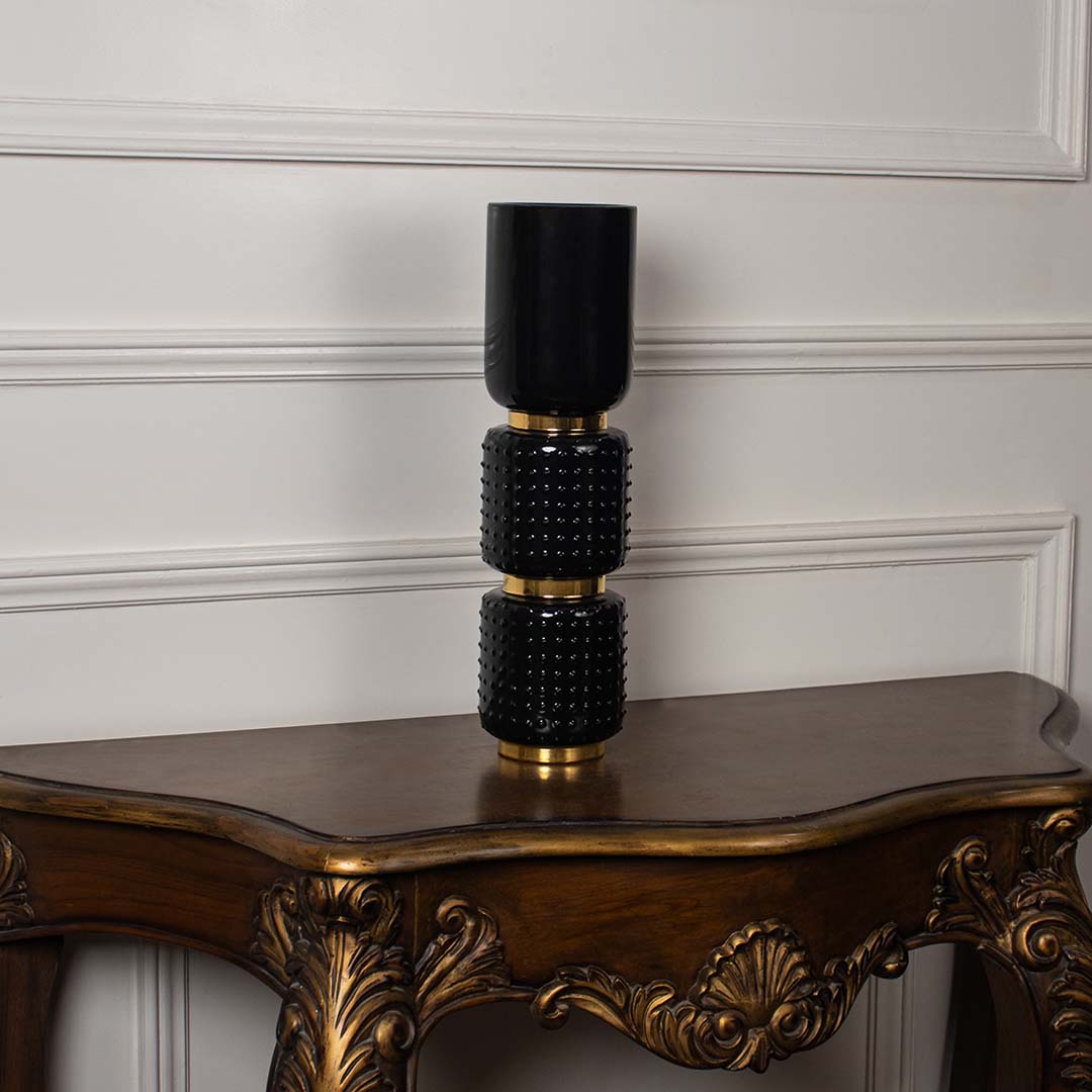 Elegant black stacked segment vase on dark wooden table for sophisticated luxury home decor and interior styling.
