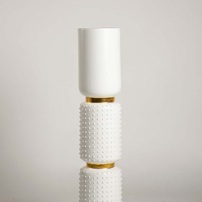 Closeup of the white and gold vase featuring detailed ceramic texture raised bumps and smooth top vessel showcasing its refined handcrafted finish.