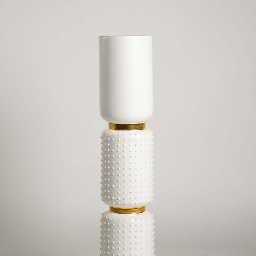Closeup of the white and gold vase featuring detailed ceramic texture raised bumps and smooth top vessel showcasing its refined handcrafted finish.