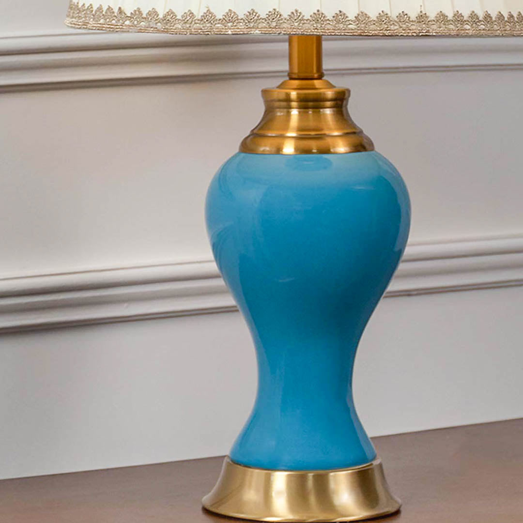 Close up table lamp with turquoise ceramic base and gold accents elegant decorative lighting for modern classic home interiors.