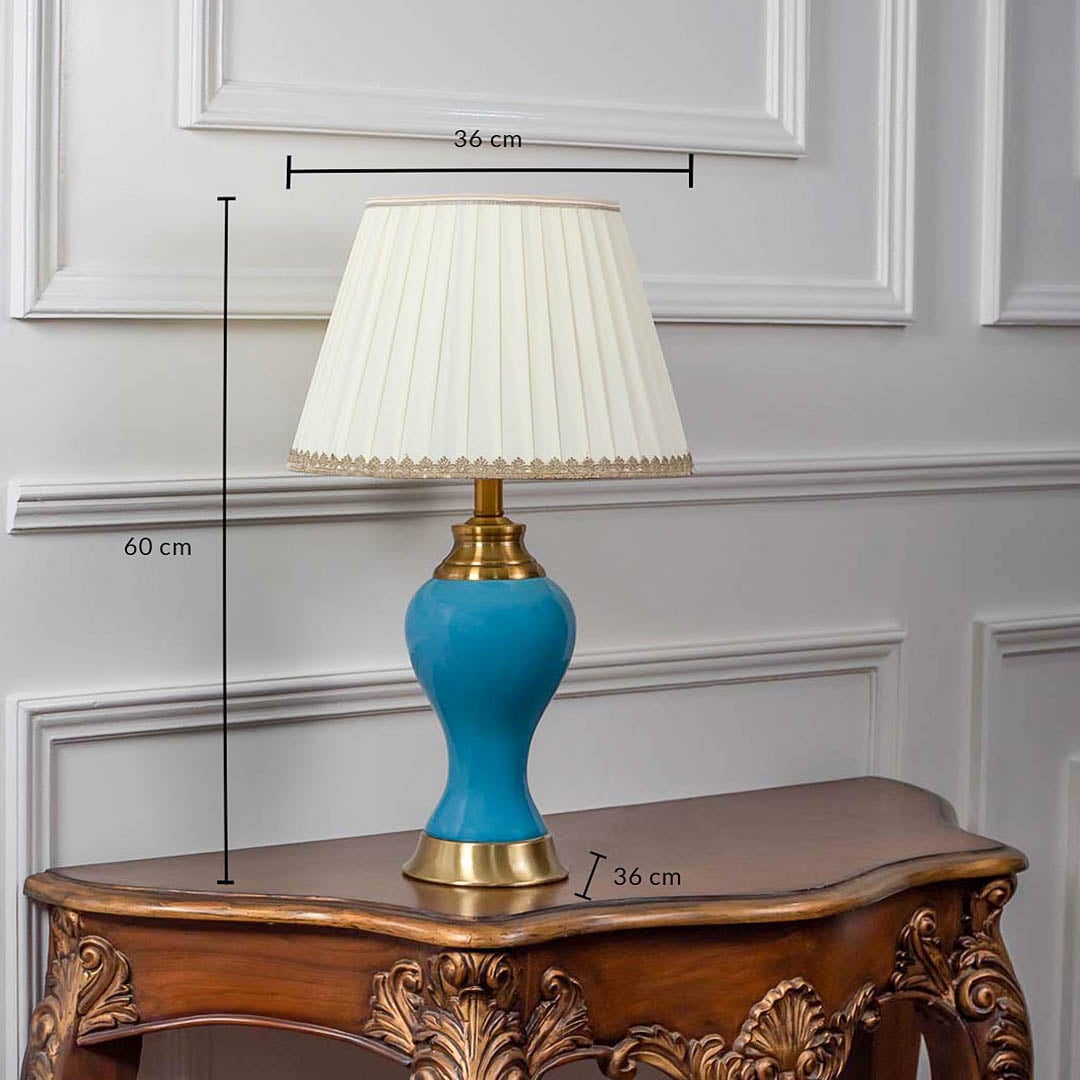 Blue ceramic table lamp with fabric shade and golden accents shown with 60cm height and 36cm width.