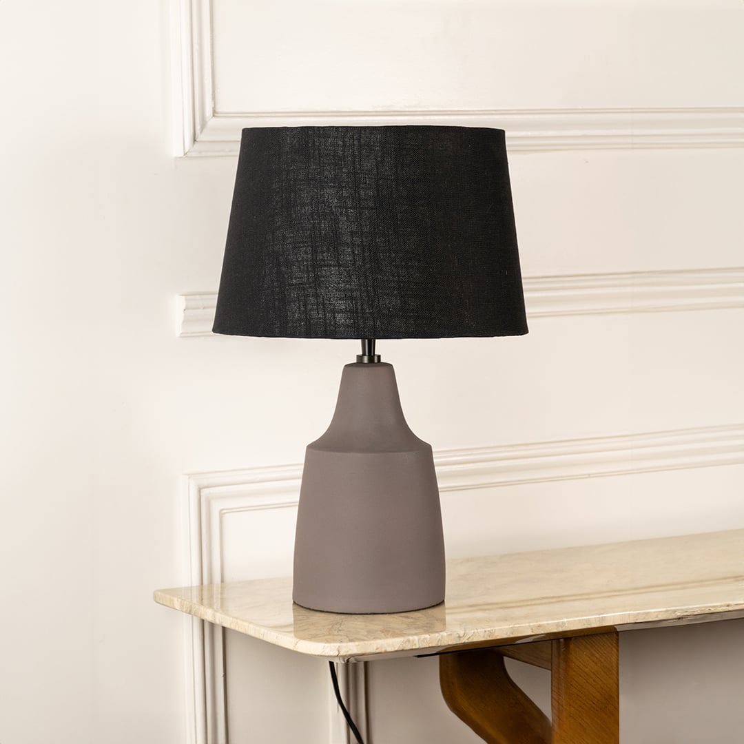 Taupe ceramic table lamp with black fabric shade and minimalist silhouette for sophisticated interior decor styling.