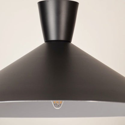 Black metal pendant light closeup highlighting refined craftsmanship and premium modern lighting design details.