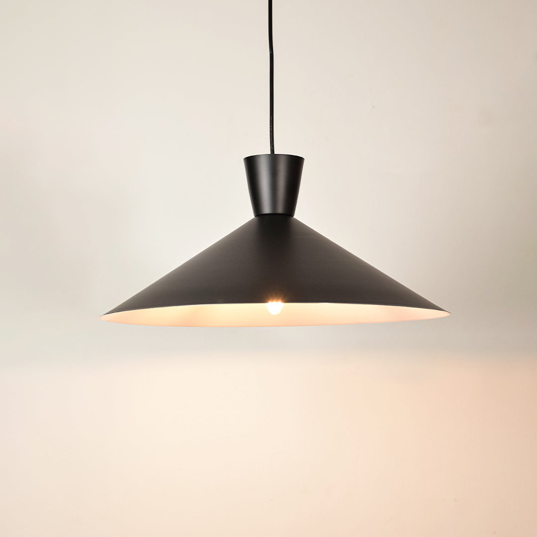 Black metal pendant light illuminated to display contemporary ceiling lighting with elegant minimalist design styling.