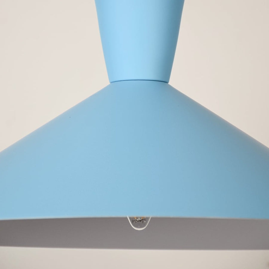 Close-up view of a modern blue metal pendant light with a wide conical shade showing the bottom opening and bulb detail.