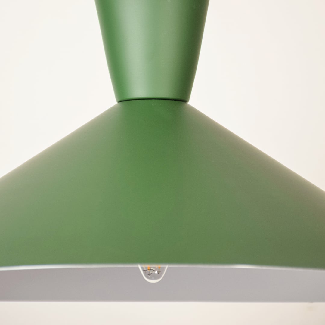 Green cone pendant light shown in close up view against soft white background with light off for earthy modern décor.