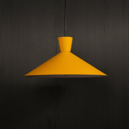 Yellow cone pendant light hanging against dark textured wall with light on for bright modern décor.