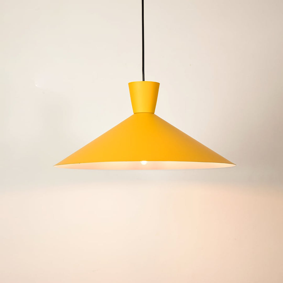 Yellow cone pendant light shown in close up view against plain background for bright modern décor.