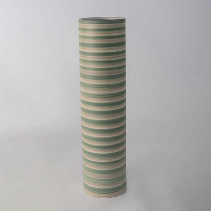 Tall striped ceramic vase in green and beige tones standing on a clean white background highlighting its smooth modern cylindrical shape.