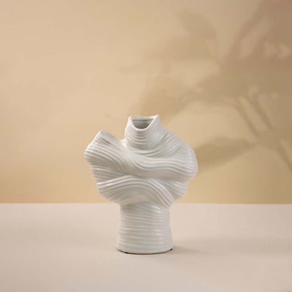 White ceramic decorative vase with sculptural twisted top design for elegant tabletop styling and modern home decor.