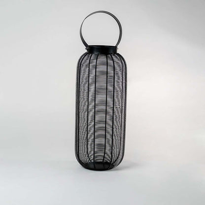 Unlit tall black wire mesh lantern isolated on white background featuring sleek cylindrical shape and sturdy handle for modern styling.