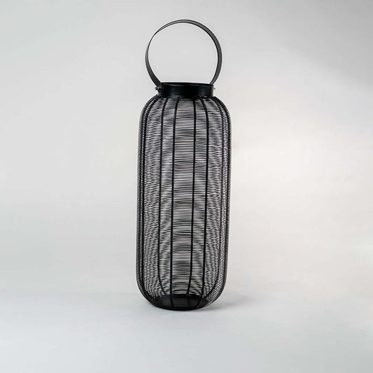 Unlit tall black wire mesh lantern isolated on white background featuring sleek cylindrical shape and sturdy handle for modern styling.