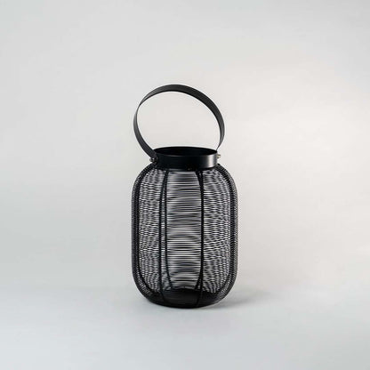 Unlit tall copper metal wire lantern standing on white background displaying sleek cylindrical shape and handle for contemporary styling.