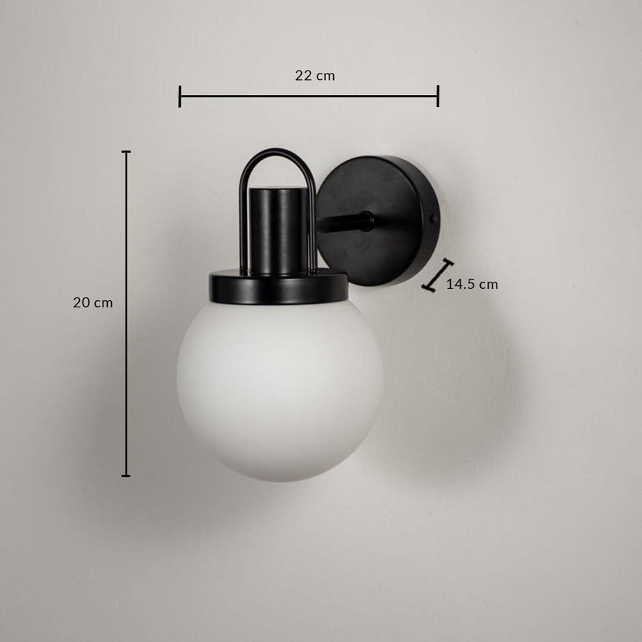Frosted glass globe wall lamp with black metal base dimension 20 cm height 22 cm width 14.5 cm depth for living room decor.