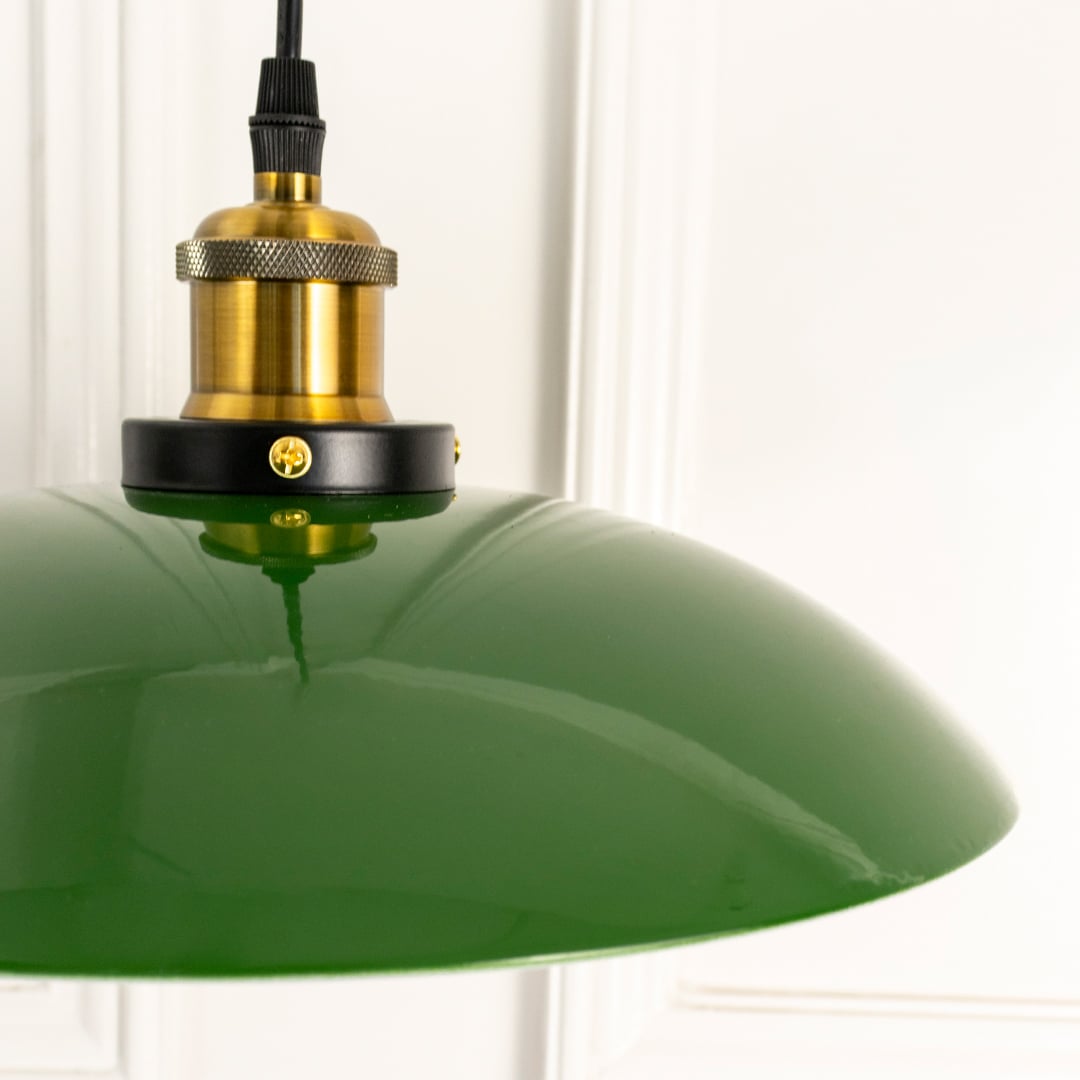 Detailed view of green dome pendant light with metal construction and antique brass finish for luxury decor.