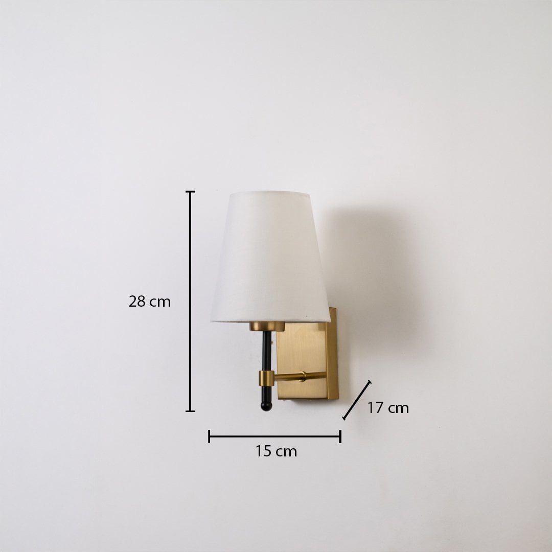 Gold metal wall light with white fabric shade shown with 28 cm height 15 cm width and 17 cm depth for accurate indoor wall placement.