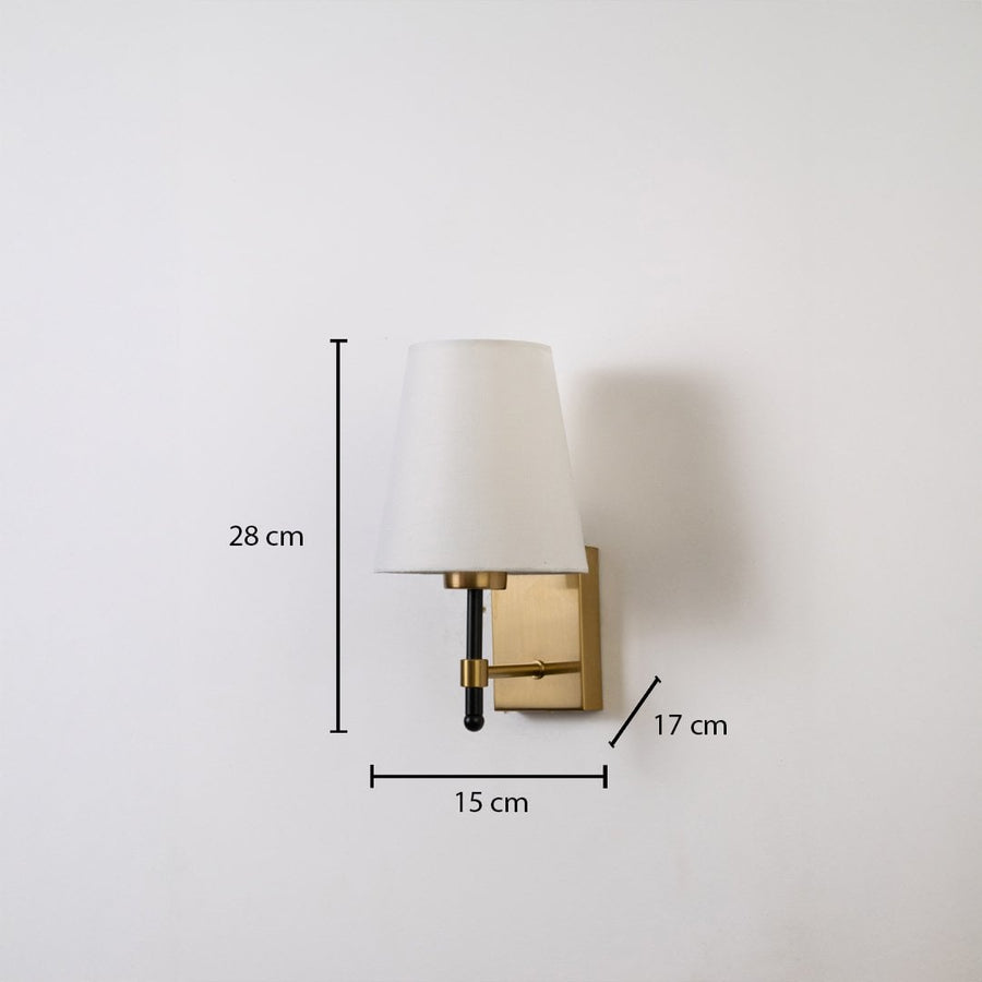 Gold metal wall light with white fabric shade shown with 28 cm height 15 cm width and 17 cm depth for accurate indoor wall placement.
