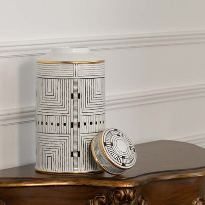 White ceramic jar with black geometric line pattern shown on simple backdrop for modern minimalist décor.