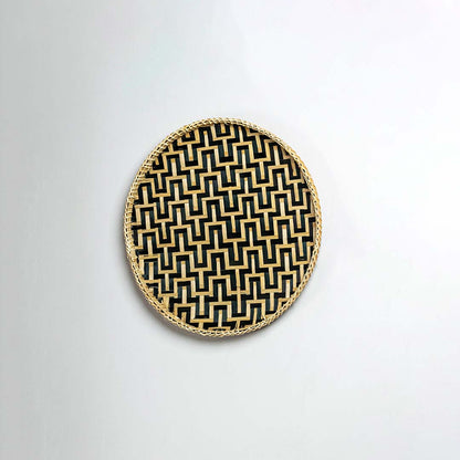 Side view of woven bamboo basket tray showing depth and handcrafted construction with black geometric zigzag pattern detail.