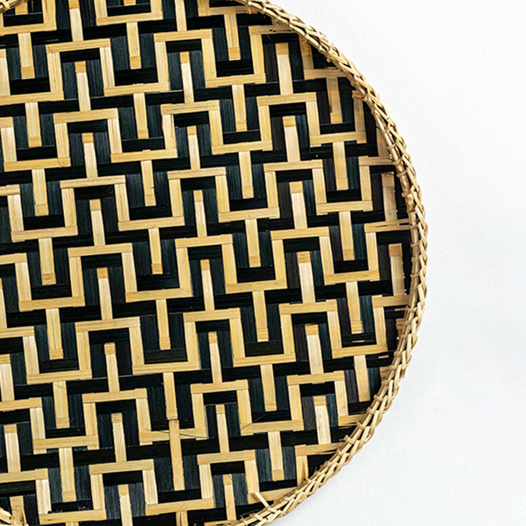 Closeup view of woven wall basket featuring black and natural zigzag pattern showing detailed handweave texture and premium decor finish.