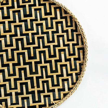 Closeup view of woven wall basket featuring black and natural zigzag pattern showing detailed handweave texture and premium decor finish.