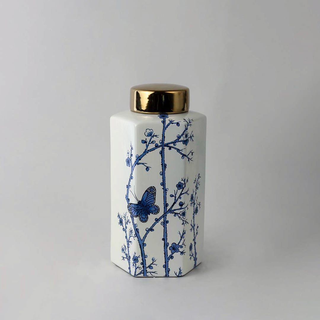 Elegant handcrafted ceramic decor jar with blue floral detailing and gold lid perfect for classic interior spaces.