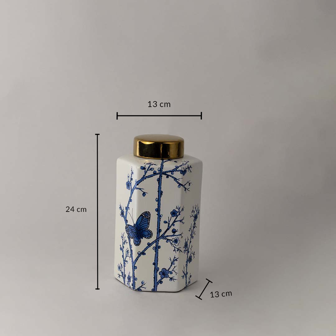 Square ceramic jar with blue floral butterfly pattern and golden lid shown with 24 cm height and 13 cm width.