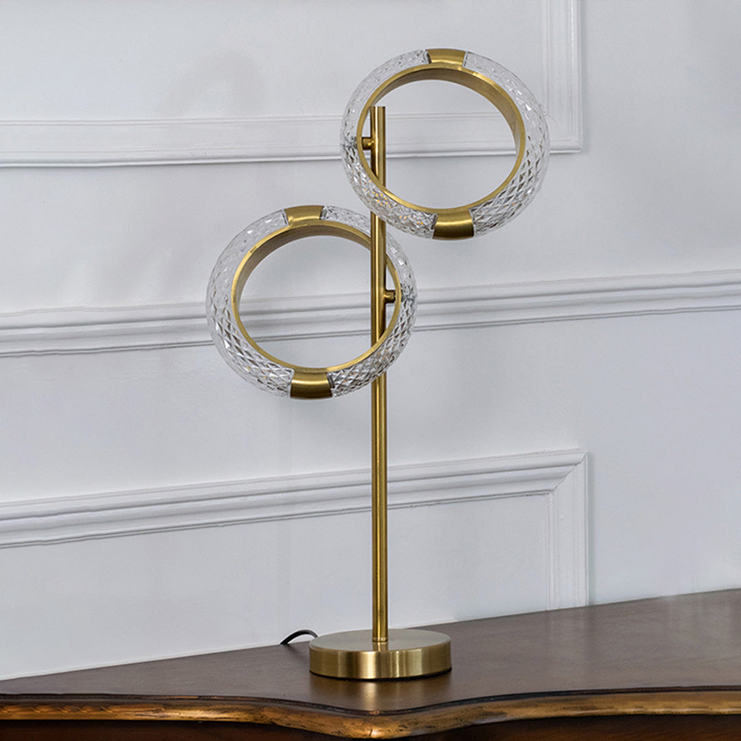 Gold metal ring table lamp with crystal accents designed for elegant modern decor and ambient table lighting indoors.