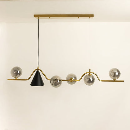 Chandelier shown against a white background with lights off emphasizing its wavy golden bar metallic globes and modern asymmetric design.
