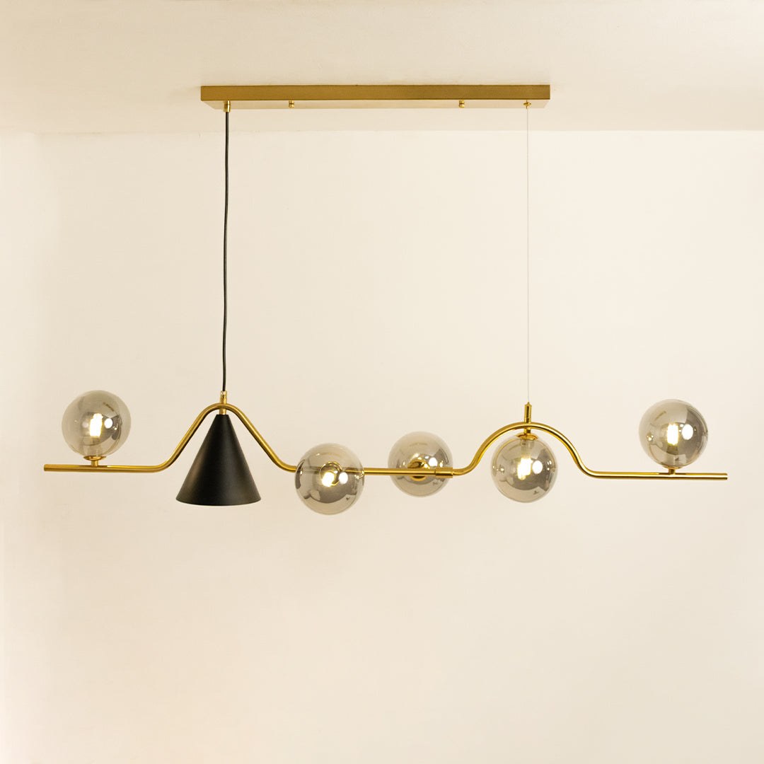 Gold metal chandelier with smoked glass globe shades and cone accent designed for elegant modern ceiling lighting.