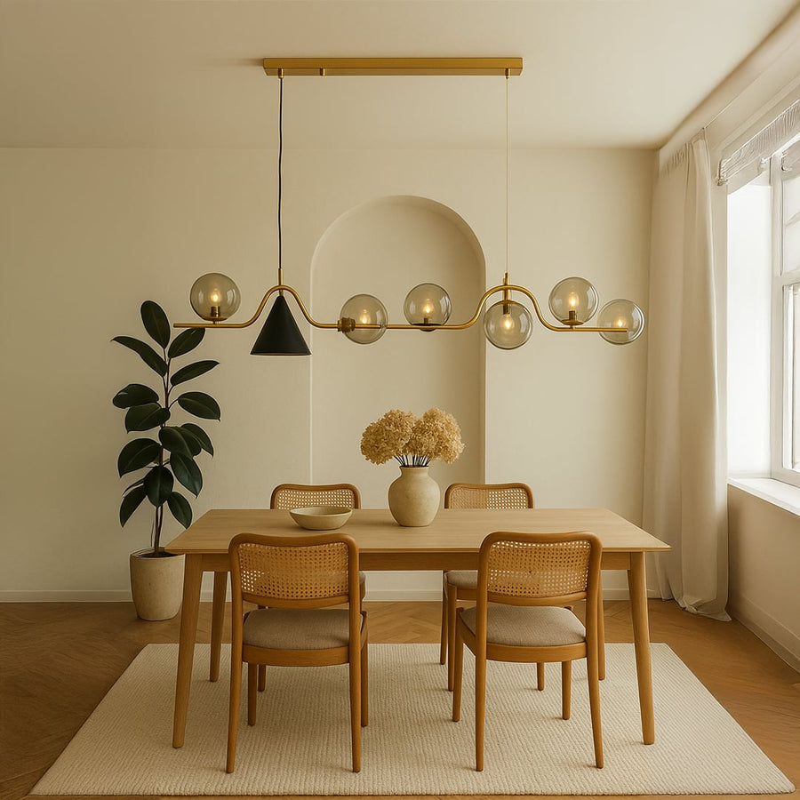 Modern chandelier styled in a warm room setup featuring metallic globes and a sleek wavy bar design for a contemporary decorative look.