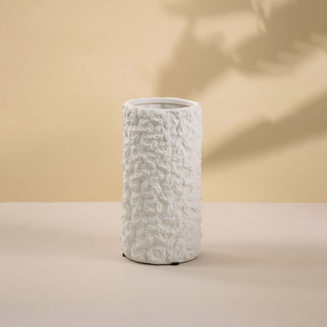 Contemporary white textured ceramic vase with matte finish highlighted against a white background for contrast.