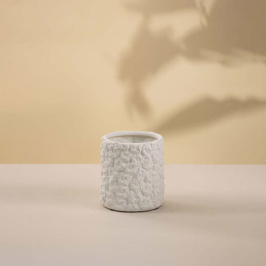 White ceramic decorative vase with textured handcrafted finish for elegant tabletop styling and modern home decor.