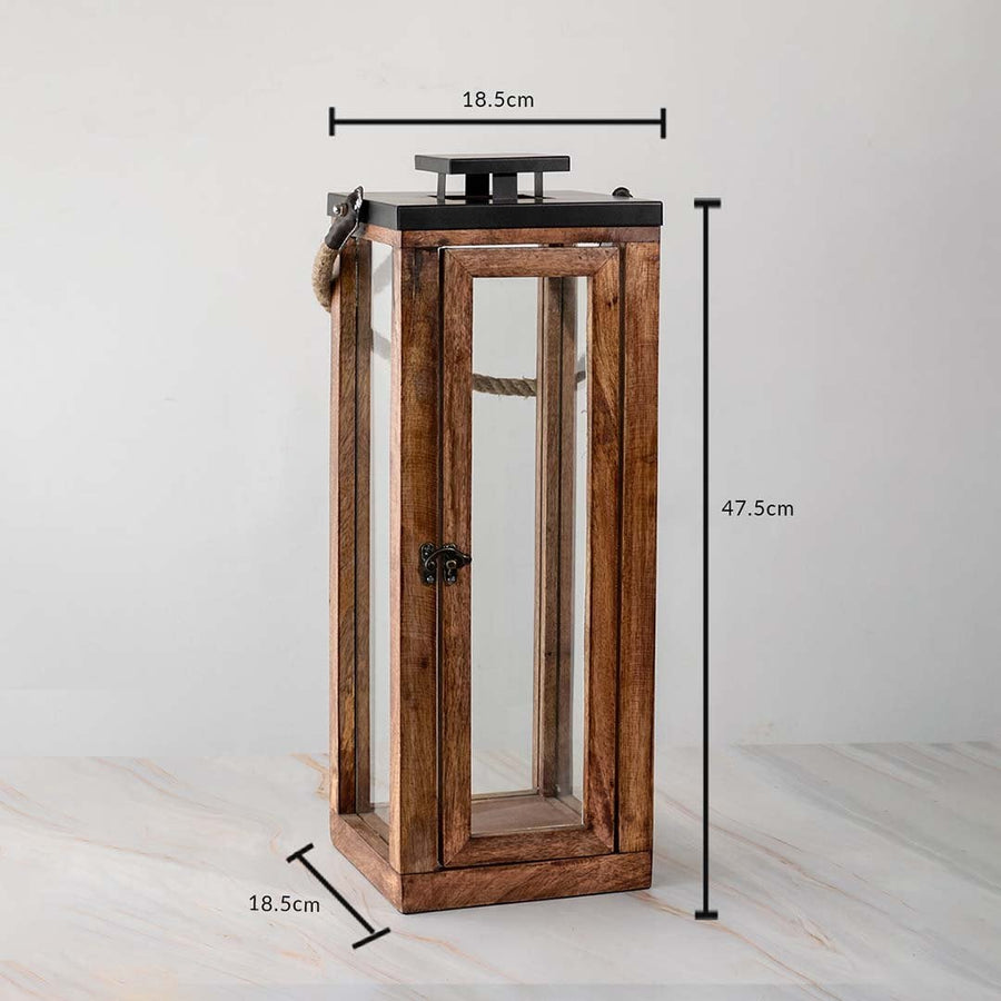 Rustic tall lantern dimensions 47.5cm height and 18.5cm width with glass panels and rope handle.