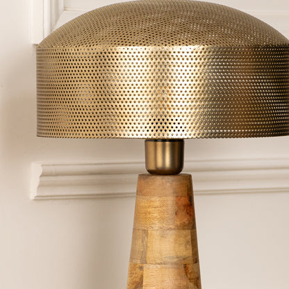 Closeup of gold metal table lamp with textured shade for elegant bedroom and living room decor styling.